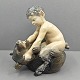 Royal 
Copenhagen; A 
figurine of 
porcelain, a 
faun with a 
bear #648. 
First. H. 16 
cm. L. app. 14 
...