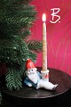 Old Christmas 
candlestick in 
painted bisque 
(porcelain) of 
Santa Claus 
lying down 
holding a ...