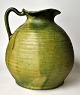 Nielsen, 
Christian 
(19th/20th 
century) 
Denmark: Vase 
with handle. 
Green glazed. 
Signed. Height: 
...