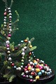 Old Christmas 
tree chain of 
small colored 
glass balls 
from around 
1940. Length 
300cm.