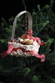 Antique Christmas tree ornament from around 1920 in the shape of a Christmas 
basket made of cardboard and tissue paper.