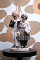 Royal Copenhagen porcelain figurine of "The Escape to America" &#8203;&#8203;
boy & girl with book and sugar pretzel...