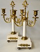 A pair of French white marble candlesticks