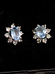 Sterling silver 
ear studs with 
aquamarine 
surrounded by 
clear stones D. 
1.1 x 1.3 cm. 
stamped ...