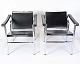 A pair of 
classic 
armchairs in 
black full 
grain leather 
with chrome 
frames. Model 
LC1 was ...