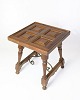 Dark wood side 
table with 
paneled top in 
geometric 
pattern. The 
table stands on 
turned legs ...