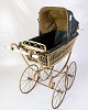 Antique pram 
from around 
1900 with 
wicker basket 
and original 
canopy. The 
pram stands on 
a ...
