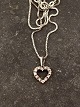 14 carat white gold heart pendant with several diamonds