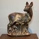 Knud Kuhn for 
Royal 
CopenhagenStone 
statue of a 
dead animal 
with a lamb. 
Signed with 
monogram ...