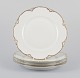 A set of four 
Haviland 
porcelain 
dinner plates.
Hand-decorated 
gold 
decoration, 
white ...