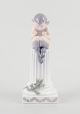 Royal 
Copenhagen, 
porcelain 
figurine.
Whistling Pan 
sitting on a 
pedestal with a 
...