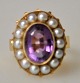 Finger ring in 
red gold, 14 k, 
with 14 pearls 
and amethyst. 
Stamp: EJØL. 
Size: 56. 
Weight: 7.2 ...