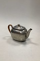 Just Andersen 
Teapot with 
wicker, in 93% 
Cast Pewter, 
No. 2421
Good 
condition, but 
with wear on 
...