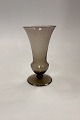 Holmegaard 
Vase, trumpet 
shape on foot. 
Smoked topaz 
colored glass. 
Designed by 
Jacob E. Bang 
...