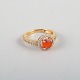 14 karat gold 
ring adorned 
with an orange 
opal and 
numerous 
brilliant-cut 
diamonds.
Size: US ...