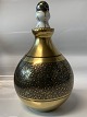 Bing & 
Grondahl, Vase 
with stopper, 
gold.
Designed by 
B.N 229.
Decoration 
number ...