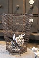 Old 6-sided 
French 
wastepaper 
basket in Fil 
de Fer with a 
really nice 
patina. H: 
45cm. Dia.: 
35cm.
