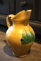 Old Italian 
ceramic wine 
jug with fine 
yellow glaze 
and twisted 
handle. The jug 
has a small 
chip ...