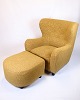 Armchair with 
ottoman from 
the 1940s. 
Upholstered in 
patterned 
yellow fabric 
with black 
legs. ...