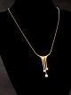 18 carat gold 
pendant 4.3 x 
2.6 cm. with 
pearls 40 cm. 
Swedish design 
jewelry stamped 
ALTON 750 ...