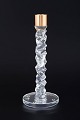 Orrefors, 
Sweden
Candleholder 
in clear 
crystal with 
faceted, 
sculptural 
shaft and brass 
...