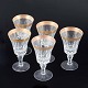 Five crystal 
glasses with 
gilt rim, 
mid-20th 
century.
Faceted cut 
crystal glasses 
on baluster ...
