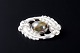 Kaj Bojesen, 
Randers
Oval silver 
brooch set with 
a cabochon-cut 
cat’s eye ...