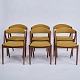 Set of six 
dining chairs, 
model 31 by Kai 
Kristiansen. 
Teak with curry 
yellow 
upholstery. 
Danish ...