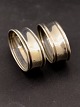 A pair of 
almost 
identical 
napkin rings 
830 silver item 
no. 620548