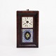 Decorative 
American clock 
from the 19th 
century, made 
of dark wood. 
The clock has a 
classic dial 
...