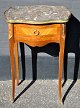 French lamp 
table, 20th 
century. With 
intarsia. With 
brass edge and 
variegated 
marble top. 
With ...