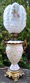 Kerosene lamp 
in faience and 
glass, 
converted to 
electricity, 
19th century. 
On a gilded 
base. ...