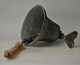 An old farm 
bell, ore, 20th 
century. 
Denmark. With 
hanging arm. 
H.: 19 cm. 
Dia.: 19 cm.