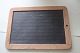 An old 
blackboard/slate 
mad of slate 
with an edge of 
wood
In a good 
condition
Articleno.: 
3-5243