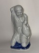 Faience 
figurine 
depicting a 
young girl on 
her knees with 
a goose in her 
lap. Made for 
Aluminia ...