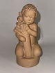 Figurine of a 
boy in ceramic. 
Made by Arno 
Malinowski for 
Peter Ipsen's 
Enke. Factory 
mark on ...