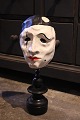 Decorative, old 
clown mask in 
painted 
papier-mâché 
mounted on old 
black painted 
wooden base. H: 
...