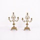 Pair of French bronze candlesticks from the 1890s. Three-armed design with ornate decoration and ...