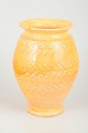 Kähler, DenmarkVase with incised leaf décor, 1930s.Tall yellow-orange ceramic vase featuring ...
