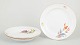 MeissenSet of three dinner plates, 1920s.Hand-painted porcelain plates with colourful floral ...