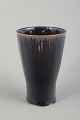RörstrandVase, mid-20th century.Tall, conical stoneware vase with a dark glaze featuring ...