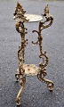 Iron pedestal, circa 1870, Denmark. On three legs with decorations of angels and dolphins. H.: ...