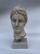 Bust, head sculpture, in plaster of Efivos Marathon Boy. Standing on white stone base. Appears ...