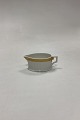 Royal Copenhagen Gold Fan Creamer No. 11562. Measures 4 cm x 8 cm / 1.57 in. x 3.14 in.