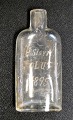 Glass flask, 1895. Engraved with name and compass. L: 13 cm.