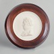 Meissen Biscuit plaque, c. 1970s.Circular relief plaque in white biscuit porcelain with a ...