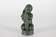 Ipsens EnkeFigurine of child with bundle of grainwith jade green glaze no. 957Designed ...