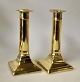 Pair of Empire candlesticks, Denmark, 19th century. Brass. On square base. H: 15.5 cm.