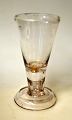 Masonic glass. Conradsminde, 1834 - 1857, Denmark. Clear glass with bent foot and hollow stem. ...