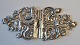 Silver belt buckle, 19th century. Rococo style. Unmarked. L.: 12 cm. H.: 5.5 cm.
